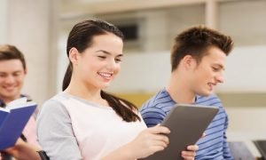 group of smiling students with tablet pc